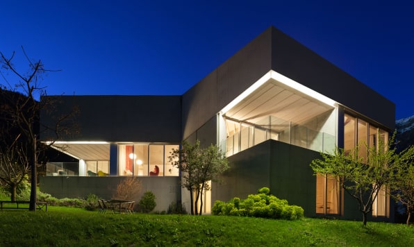 Night view of a contemporary black villa.