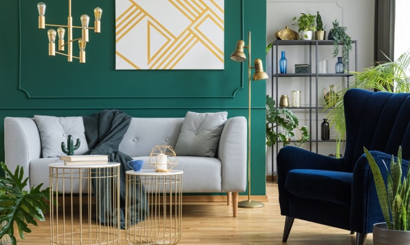 Gray sofa and navy armchair in modern elegant interior.